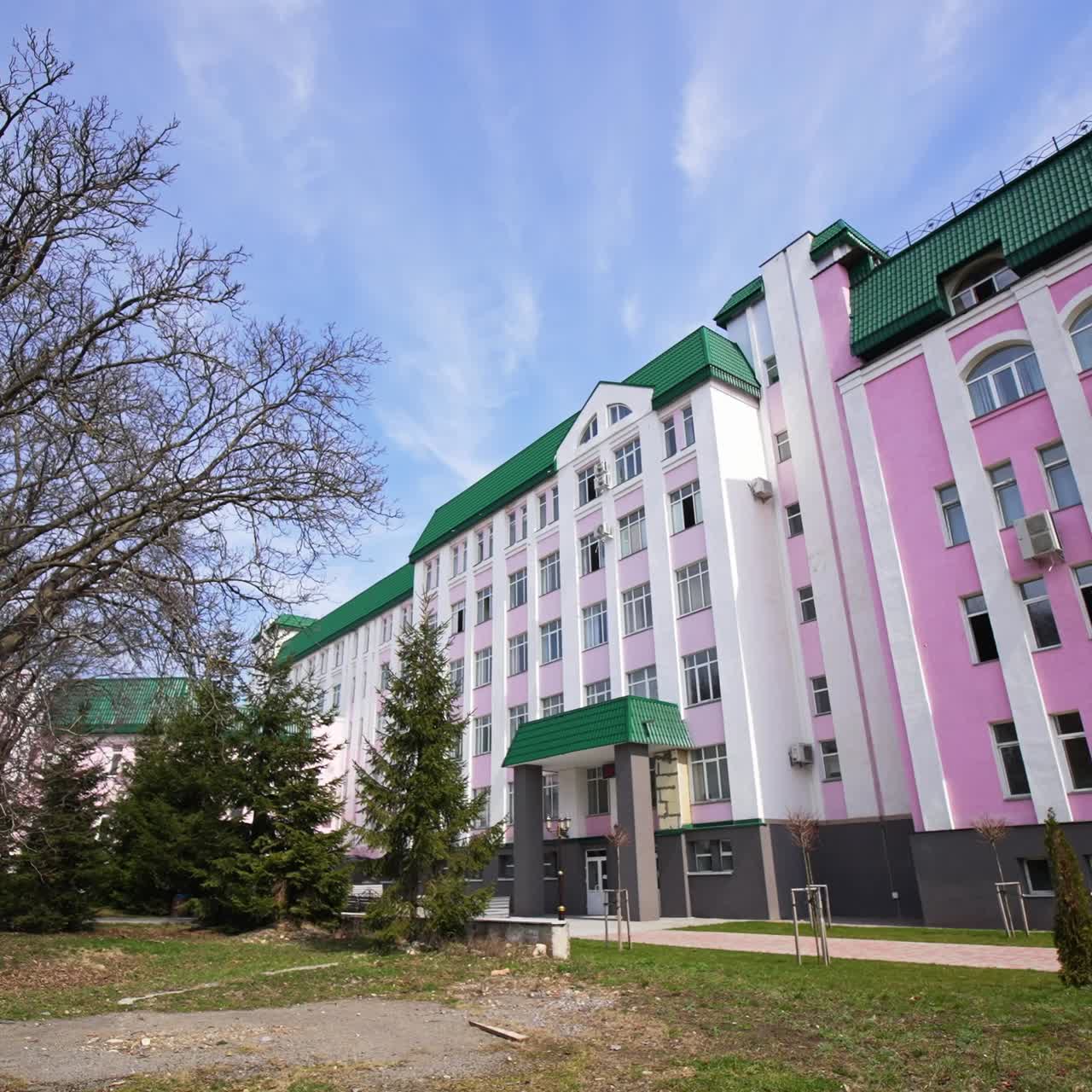 Modern educational establishment for higher education. Main student corpus of university. Park leading to the main building entrance