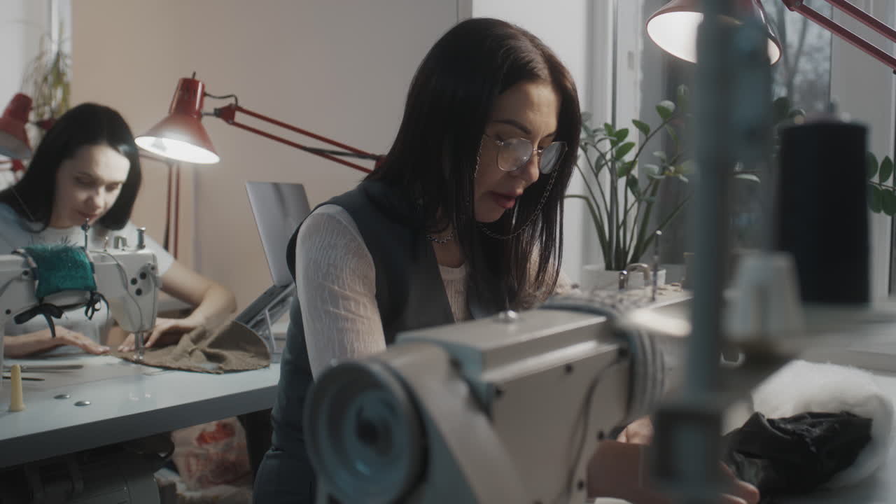 Two Women Working on Sewing Machines in a Workshop
