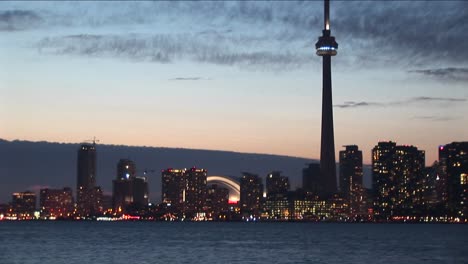 the camera pans back and forth from downtown toronto to the cntower and back for a creative perspective