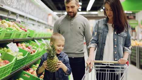 family shopping for fruits at grocery store