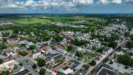 high wide panorama of city in usa surrounded by rural farmland