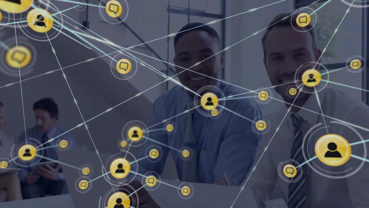 Male colleagues pointing laptop initiating glowing network icons and expanding business network web