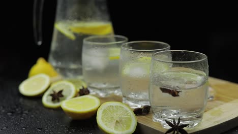 Add-ice-cubes-to-lemon-juice-in-glass-with-lemon-slices.-Alcoholic-cocktail