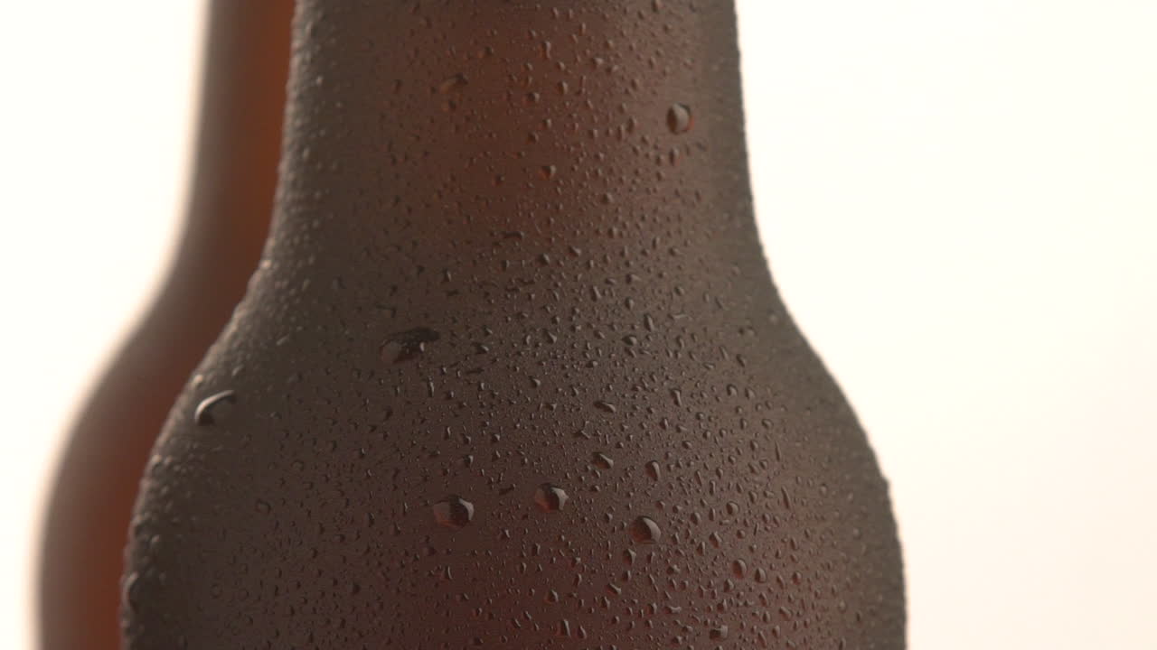 Three beer bottle rotating on white background