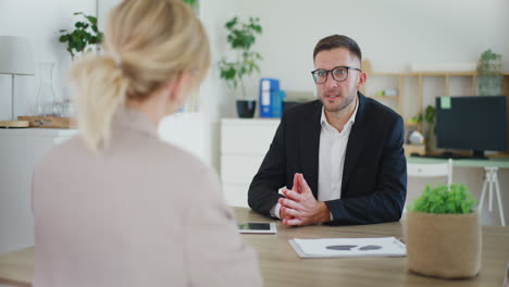 real estate agent discussing with client in office