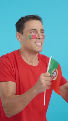 Nervous man cheering for Portugal during a match looking away
