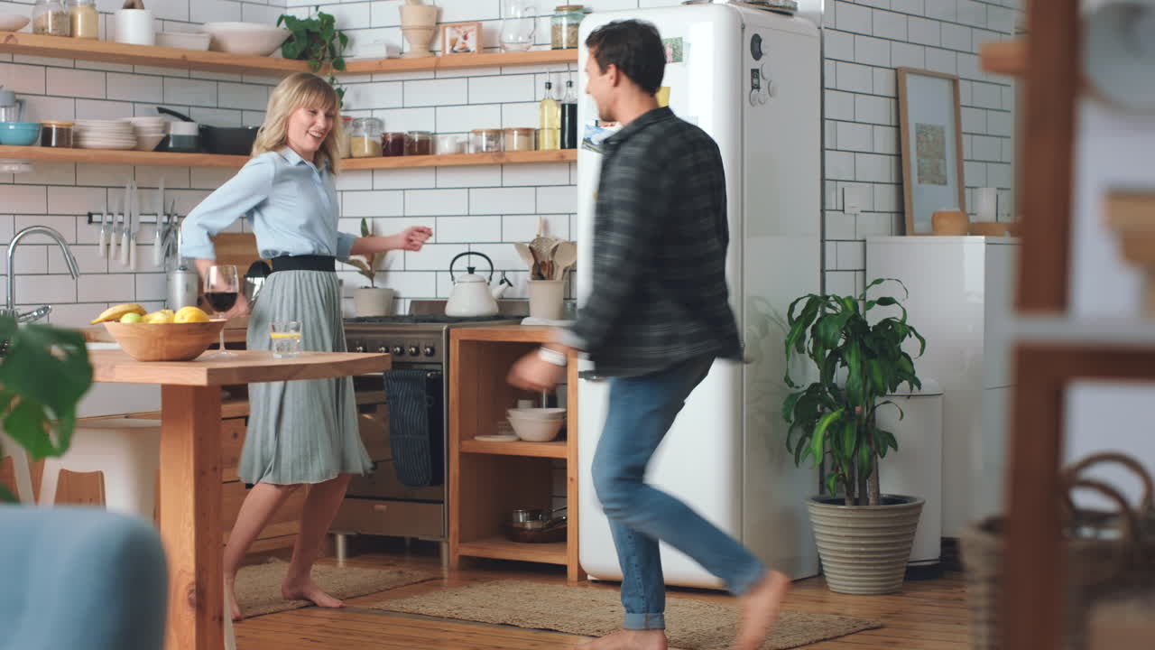 Dance, freedom and love with couple in kitchen