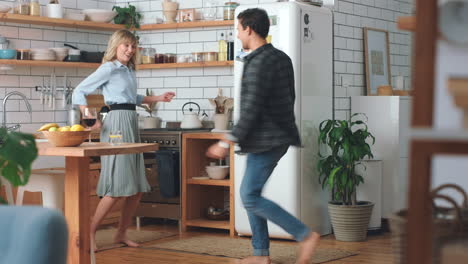 Dance,-freedom-and-love-with-couple-in-kitchen