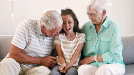 grandparents tickling their granddaughter