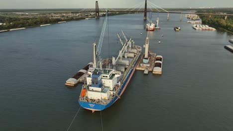 Aerial-pan-view-of-ships-being-loaded-by-crane