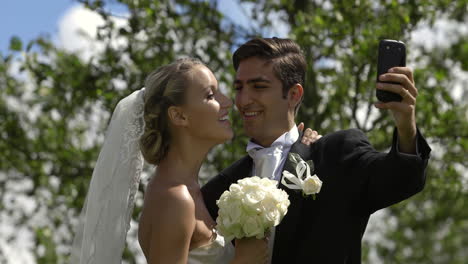 Bride-and-groom-taking-a-selfie-outside