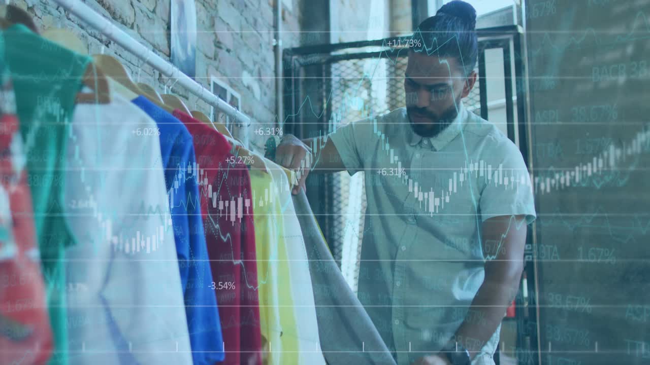 Fashion designer selecting shirt on rack and measuring width with tape and comparing overlay graphs