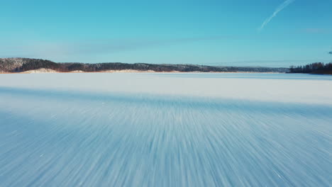 fast flying drone camera view over frozen lake