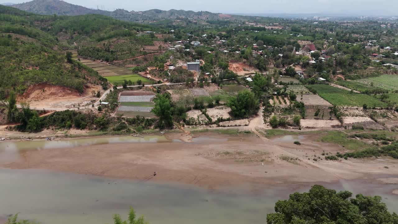 Drone footage above a river along the countryside in Kon Tum province, central highland Vietnam. Beautiful scenery and villages Bahnar a minority from this province