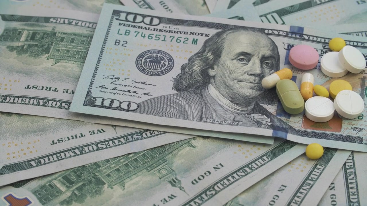 Pills and Capsules Scattered on US Dollar Bills