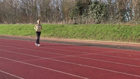 woman running at track and field competition