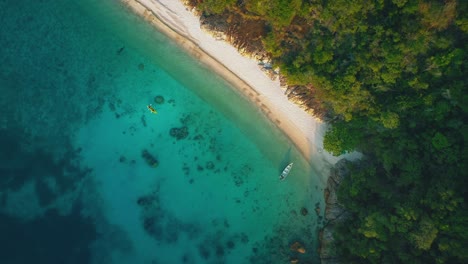 tropical perhentian islands in malaysia, beautiful aerial drone cinemagraph / seamless video loop in 4k uhd. clear blue water moving gently in waves, white sandy beaches and palm trees. perfect place for island adventures and honeymoon.