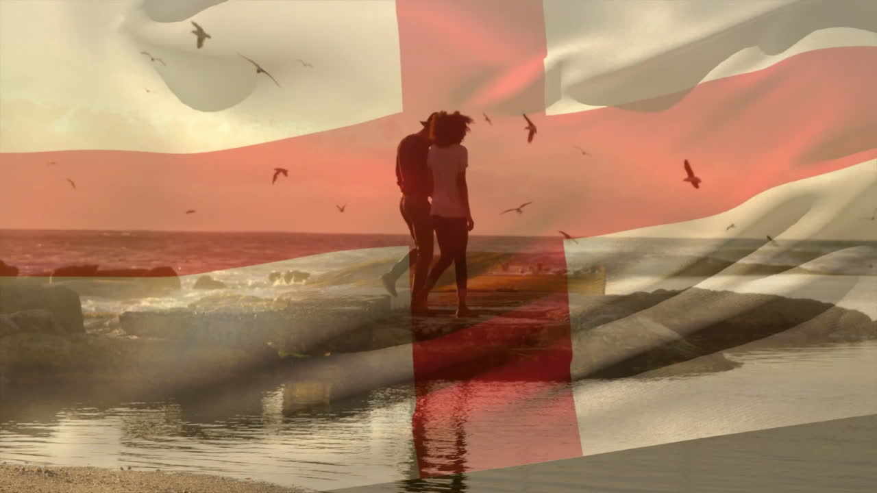 animación de la bandera de inglaterra sobre una pareja afroamericana caminando por la playa