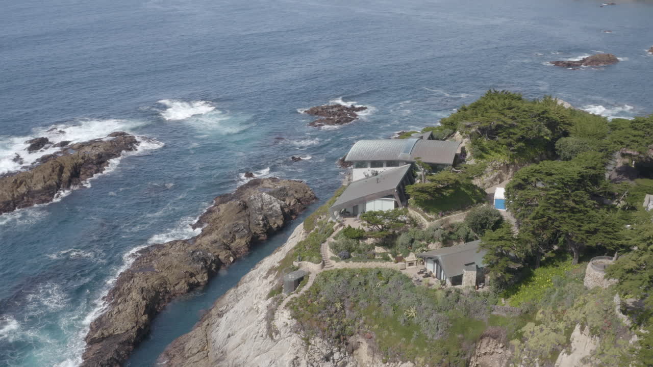 4K aerial of spectacular modern cliffside mansion in the Carmel Highlands with extraordinary ocean view.