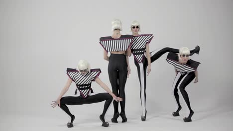 stylish women in striped outfits performing dance