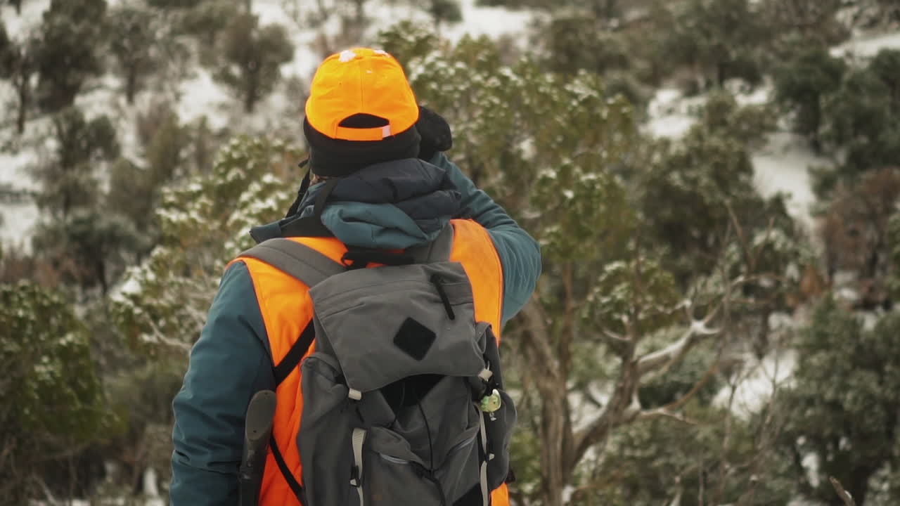 Hunter Looking For Animals In A Cold Winter Day At Snowy Mountains