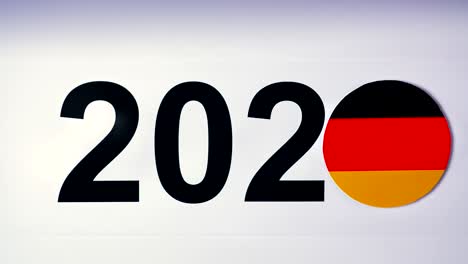 illustration, new year, male hand put on the table on german flag, country ball, 2020