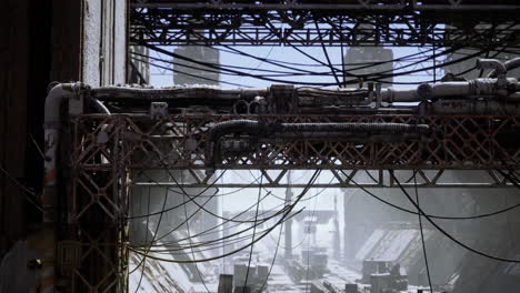 abandoned industrial site with rusted structures and tangled wires in daylight