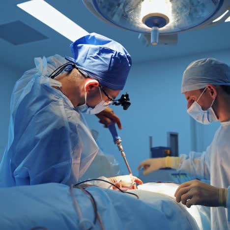 neurosurgeons in operation room. attentive doctors in surgical glasses provide operation. selective focus