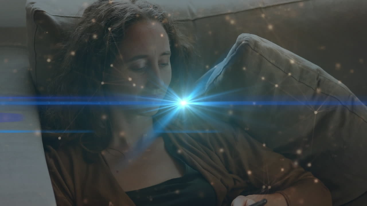 animación de la red de conexiones y senderos de luz sobre la mujer biracial usando teléfono inteligente