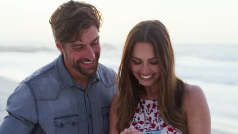 beach, smartphone and happy couple with funny