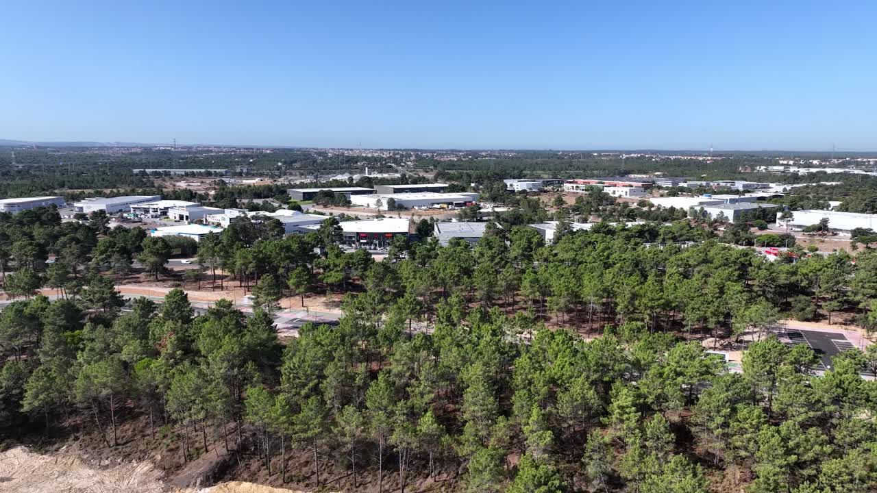 Drone shot flying over the forest and the industrial area in Seixal, south of Lisbon