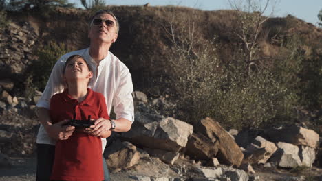 father and son flying a drone