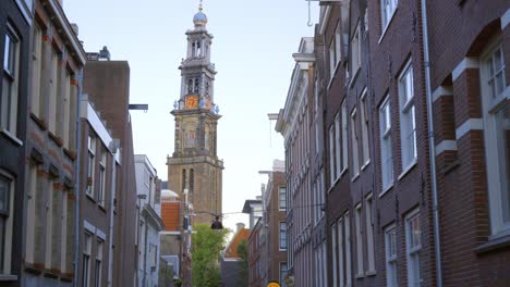 wide tracking shot revealing the bell tower of the 17th century church the westerkerk in amsterdam, where rembrandt is buried