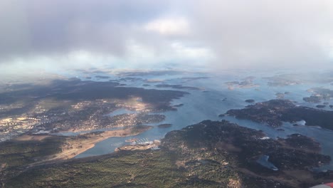 view-from-an-airplane-flying-above-islands-in-the-same-height-with-the-clouds