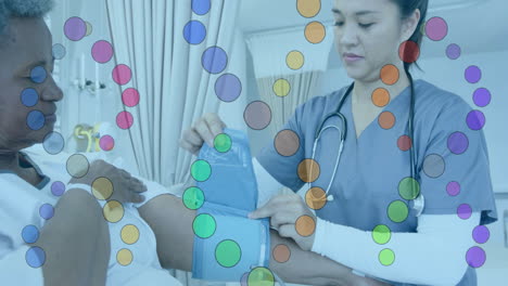 Animation-of-dna-strands-over-diverse-female-doctor-and-patient-in-hospital