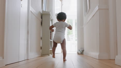 happy baby girl learning to walk toddler exploring home curious infant walking through house enjoying childhood