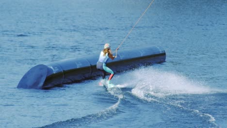 People-enjoys-riding-wakeboard-on-lake.-Young-woman-water-skiing