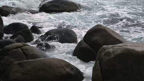 waves crashing against rocks on a rocky coastline