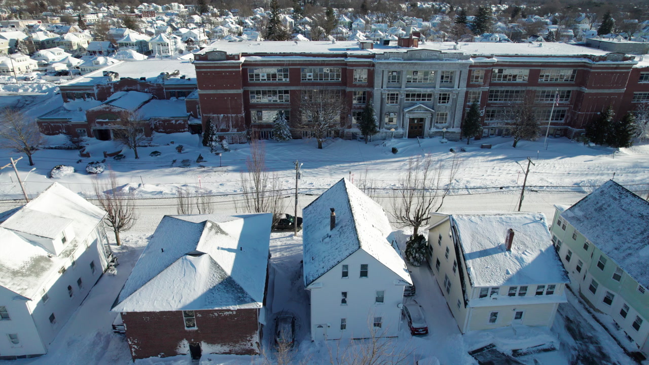 Aerial view of the blizzard of 2026 in Cranston, Rhode Island with impassable roads and snow covered roof tops.