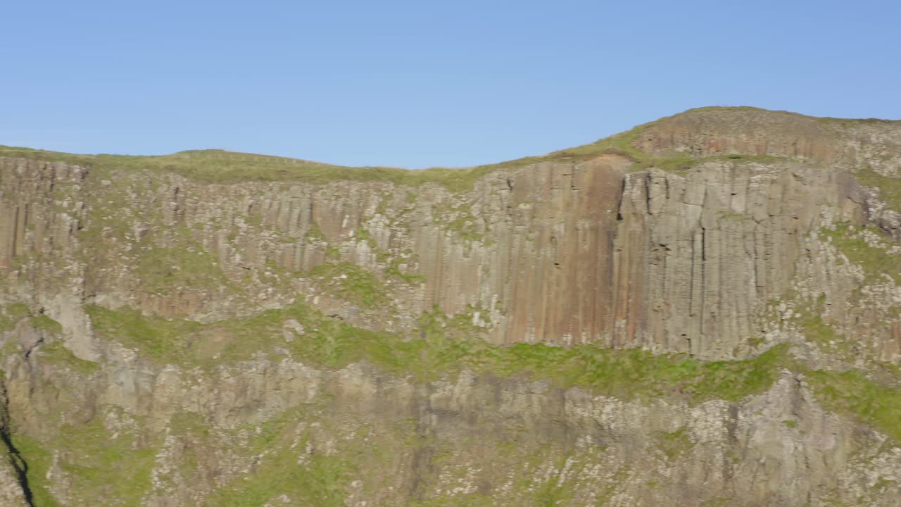 Aerial pan showing the cliffs at Giants causeway. Northern Ireland
