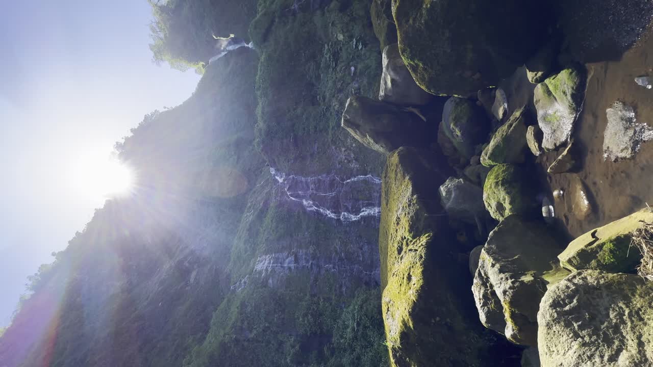 Woman Hiking to a Waterfall