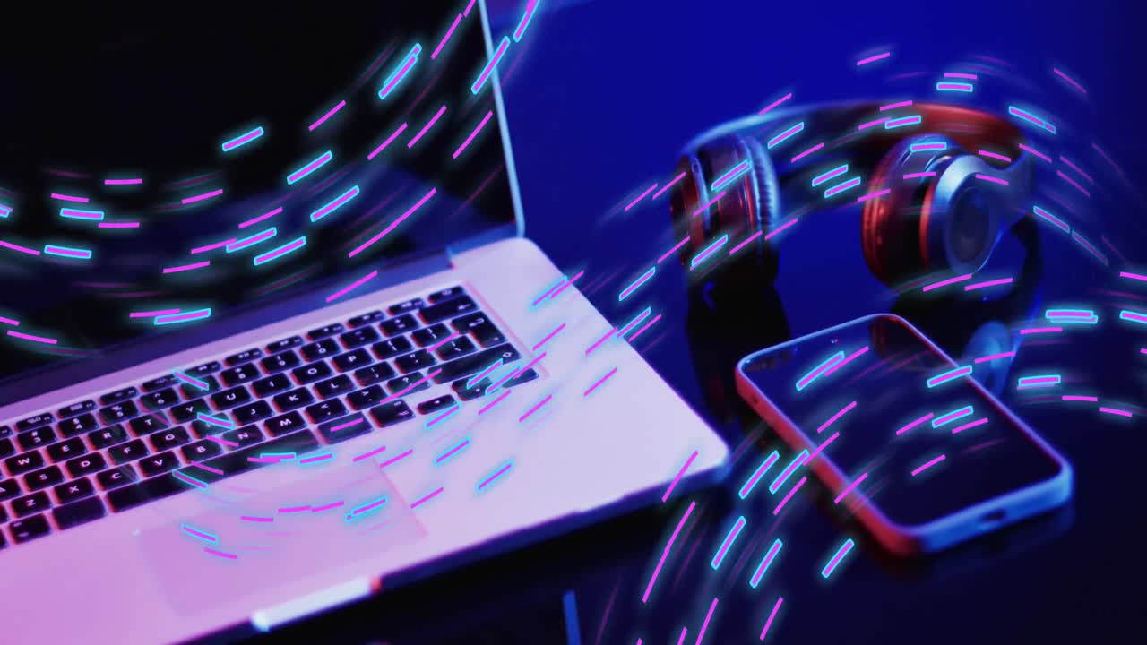 Animation of neon light trails over video game computer equipment