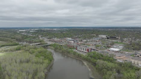 flying over minnesota river towards the downtown shakopee in minnesota, usa. - aerial shot