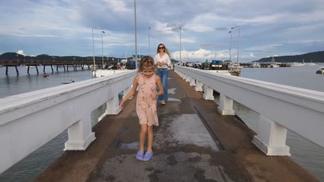 mother and daughter on a pier