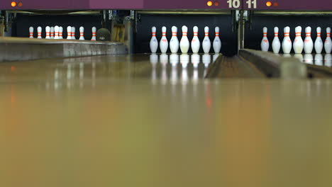 A-pinsetter-sets-pins-at-a-bowling-alley,-low-angle