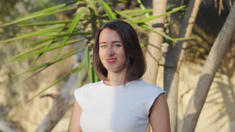portrait of a young woman in a white shirt outdoors