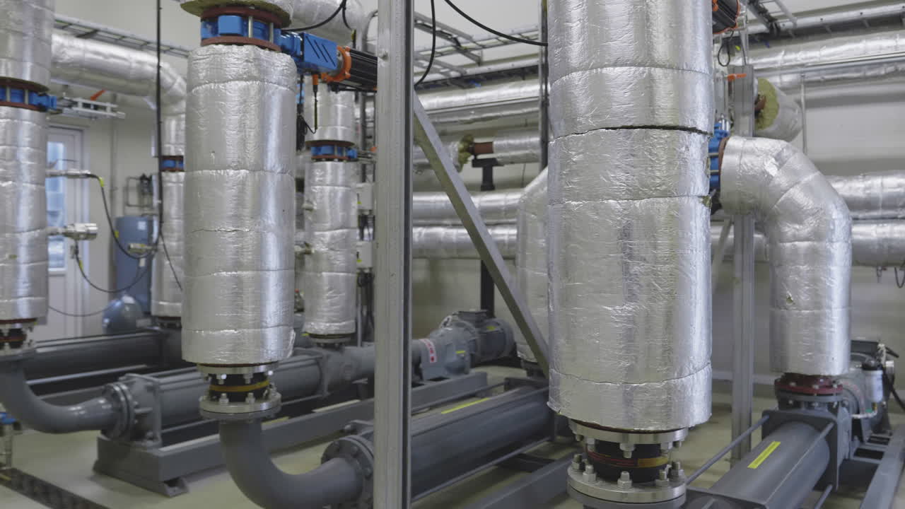 Inside view of a modern biogas installation in rural Denmark, showing tanks, pipes, and clean energy infrastructure producing renewable gas from organic waste