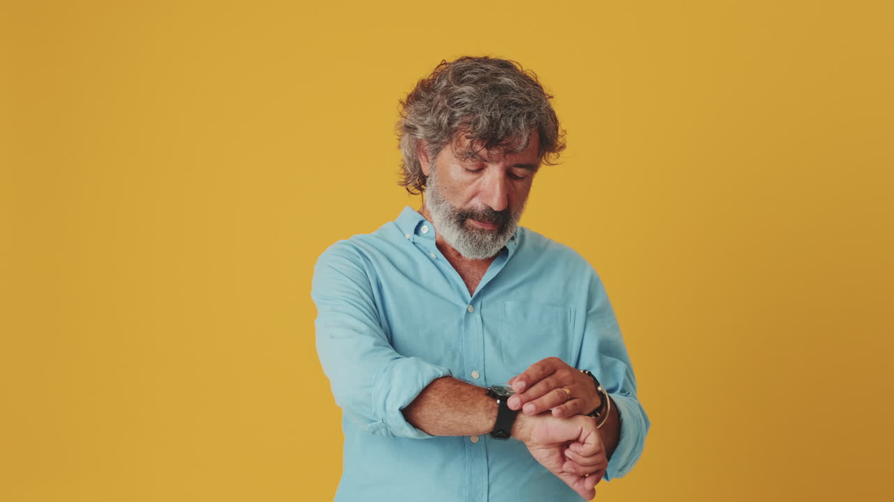 Mature Man Looking Up and Checking His Watch