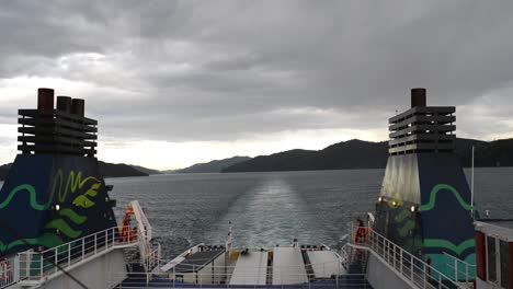 static view from rear of ferry steering through the picturesque queen charlotte sound on new zealand's south island