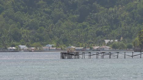 tranquil tropical island village with wooden pier